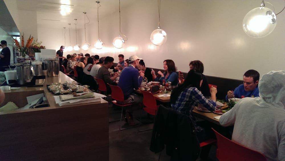 Busy dining room under pendant lights