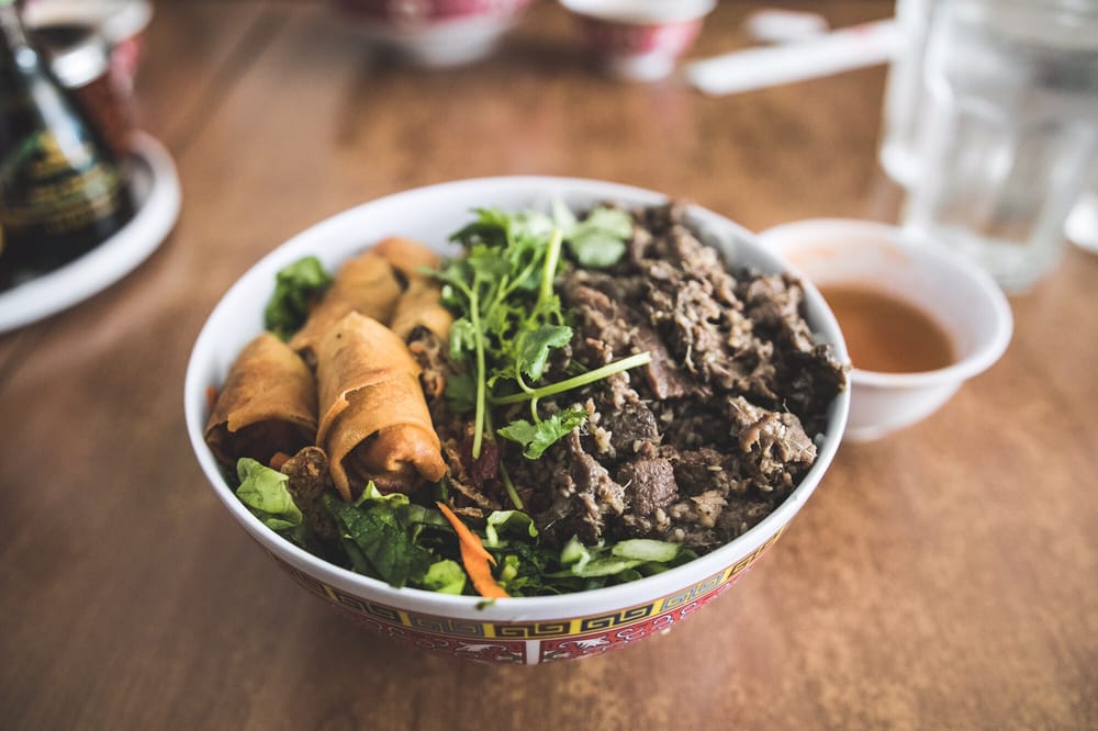 Vermicelli bowl with egg rolls and grilled beef